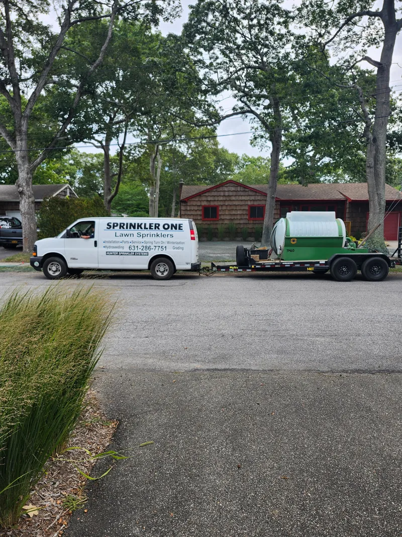 Sprinkler One service van and hydroseeding equipment at a project site.