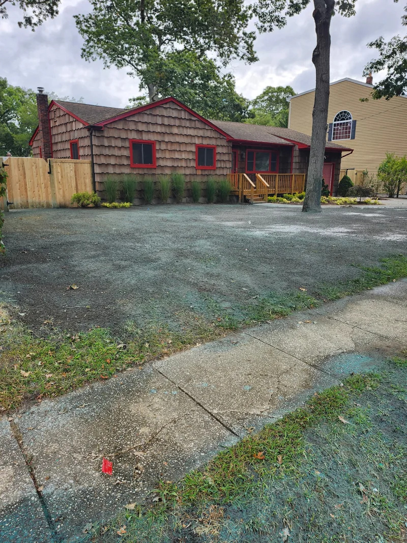 Hydroseed covering the ground beside a timber building before grass establishment.